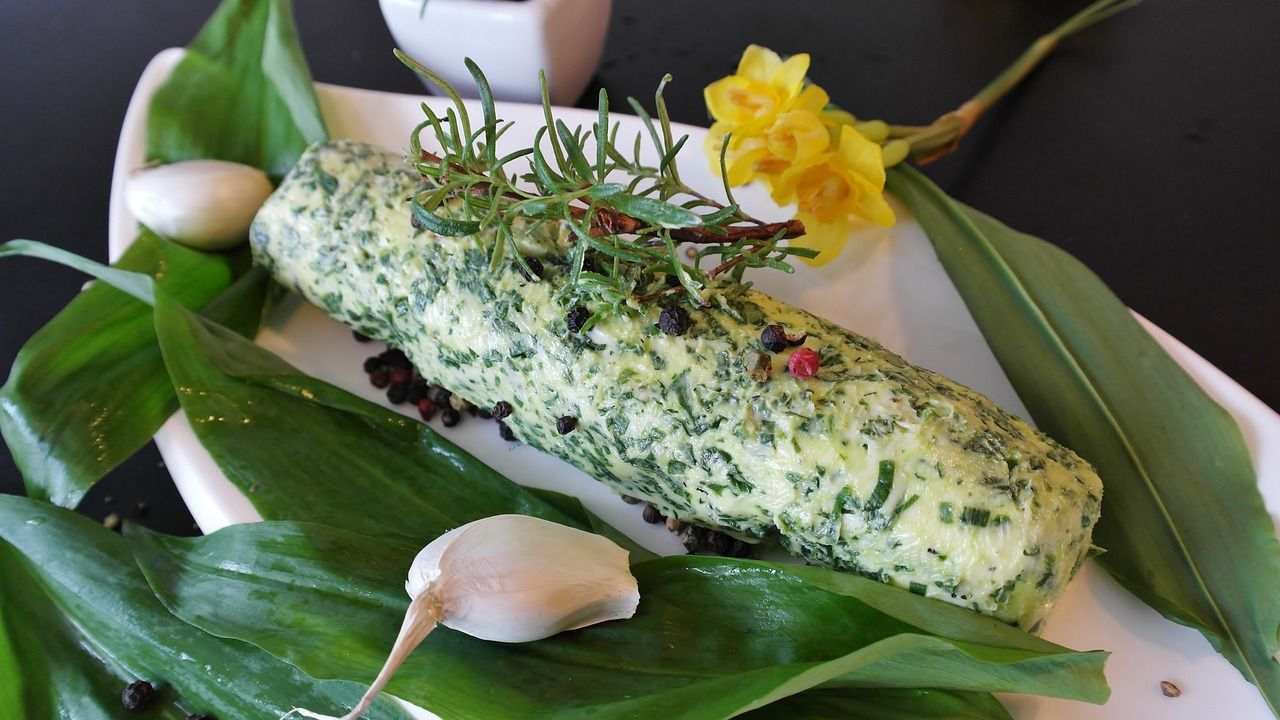 Picture of different herbs and flowers on a plate.